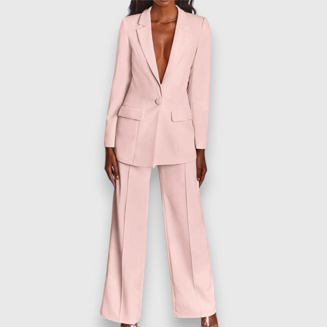 Women's tailored suit set in pale pink featuring single-breasted blazer and wide-leg trousers on model