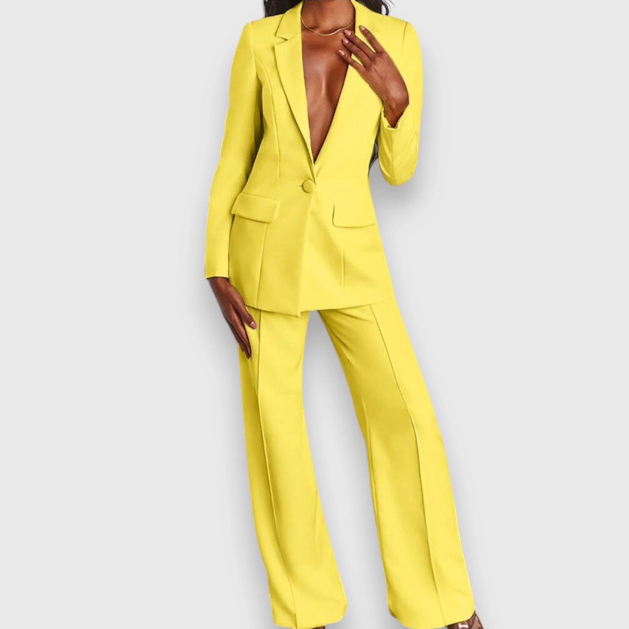 Detail of single-button closure and fitted waist on women's tailored blazer