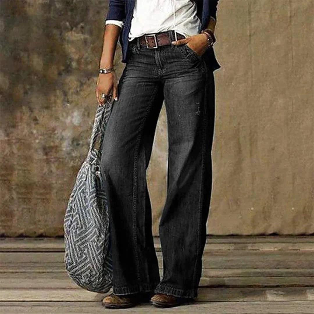 Full-length women's wide leg jeans in retro denim with worn-in faded finish and loose fit