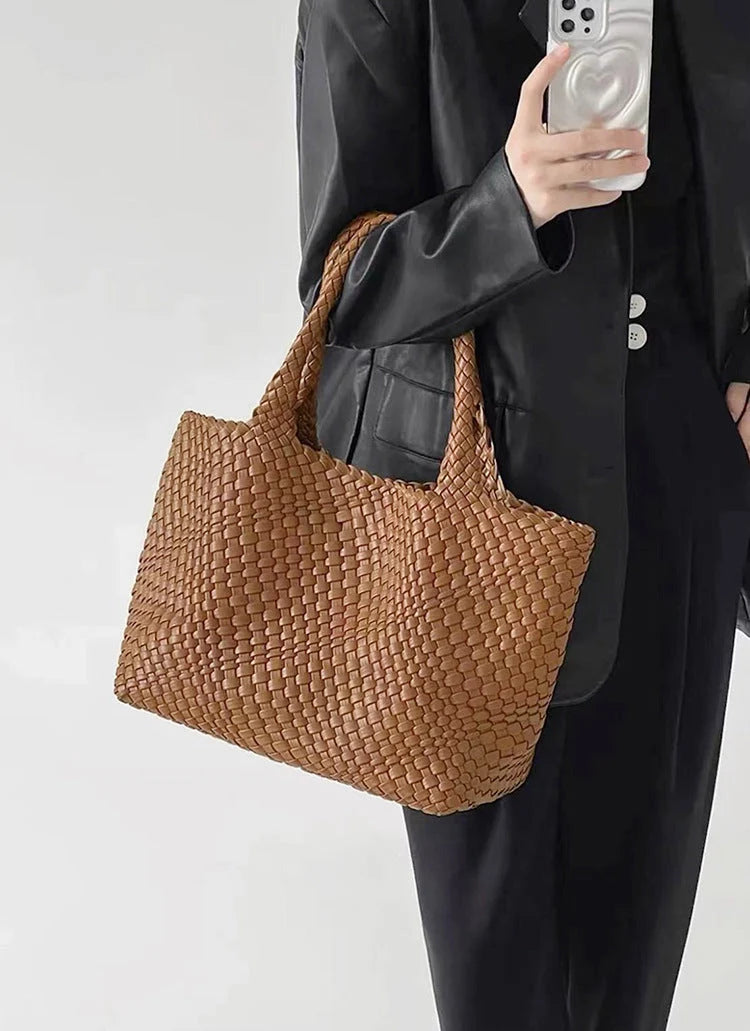 Detail of woven tote bag handle showing continuous basket weave construction