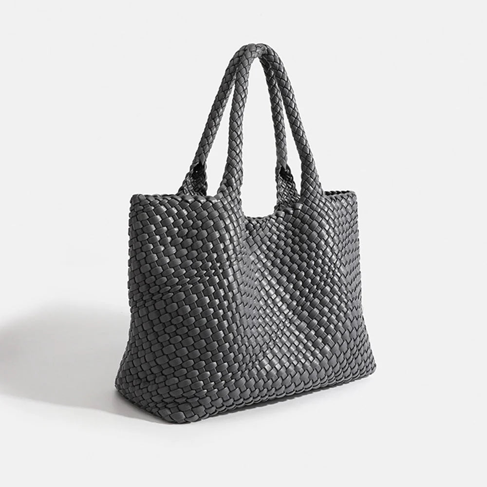 Light green woven tote bag showing structured shape and woven handle detail