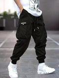 Men's cargo trousers in black with elasticated ankle cuffs and multiple pockets worn with white trainers