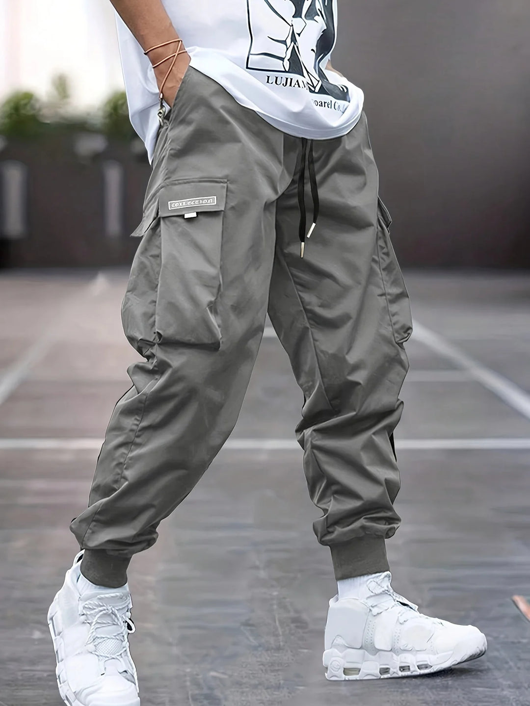 Side view of men's cargo trousers showing relaxed fit and cargo pocket detailing with branded label