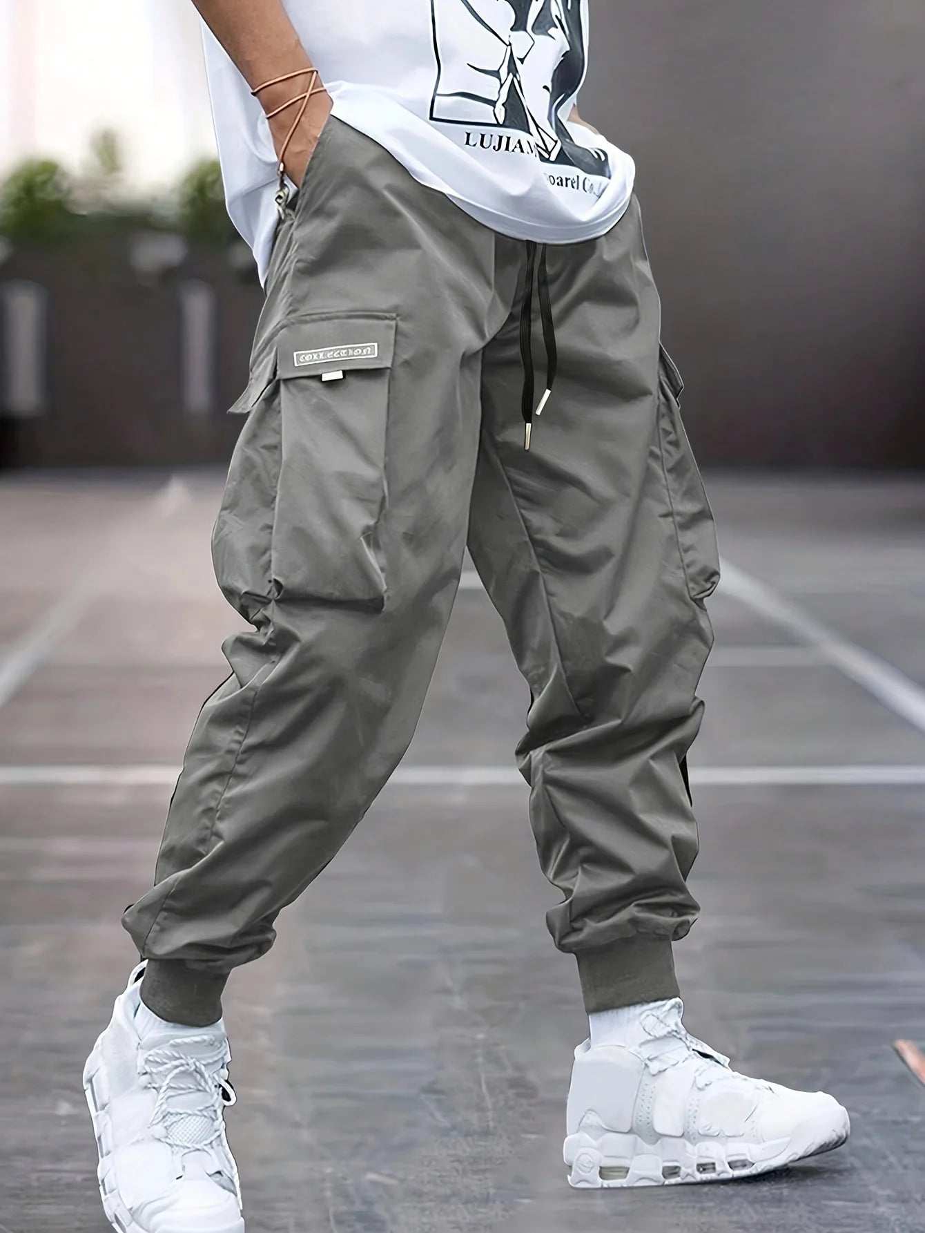 Side view of men's cargo trousers showing relaxed fit and cargo pocket detailing with branded label