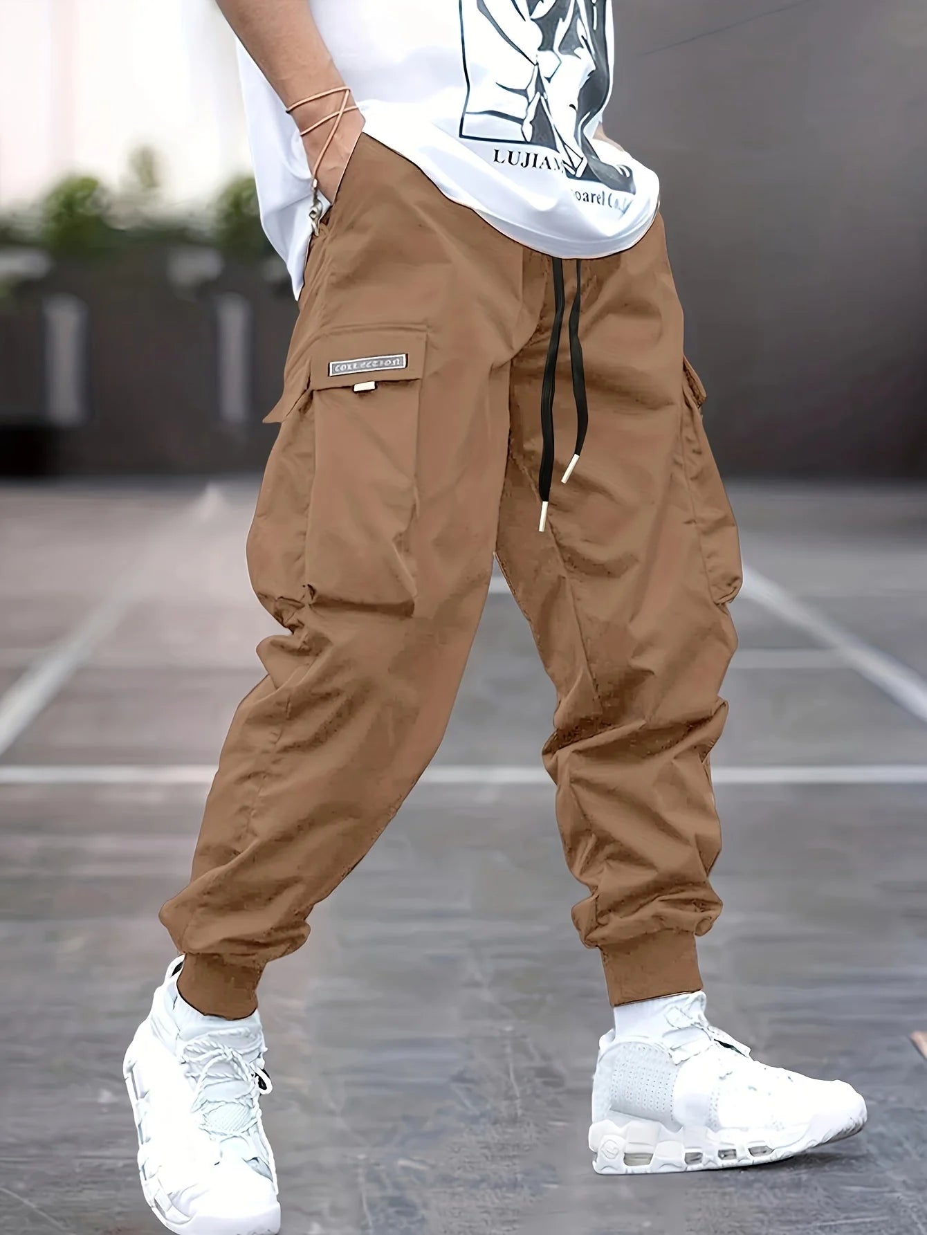 Men's cargo trousers styled with graphic long-sleeve tee for casual streetwear look