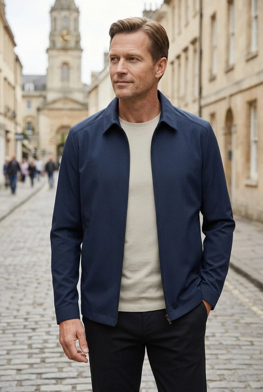 Side view of men's navy Harrington jacket displaying relaxed fit and layering versatility