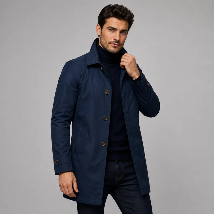 Close-up view of beige longline coat showing structured collar and button front detail with smooth fabric finish
