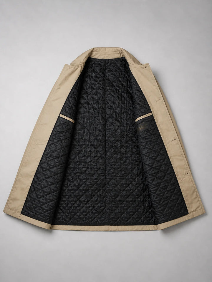 Detail shot of beige coat's functional pocket and button closure with clean tailored lines and woven fabric texture