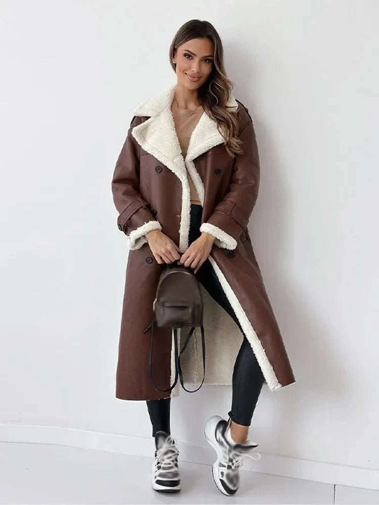 Detail of double-breasted button closure and self-tie belt on women's trench coat
