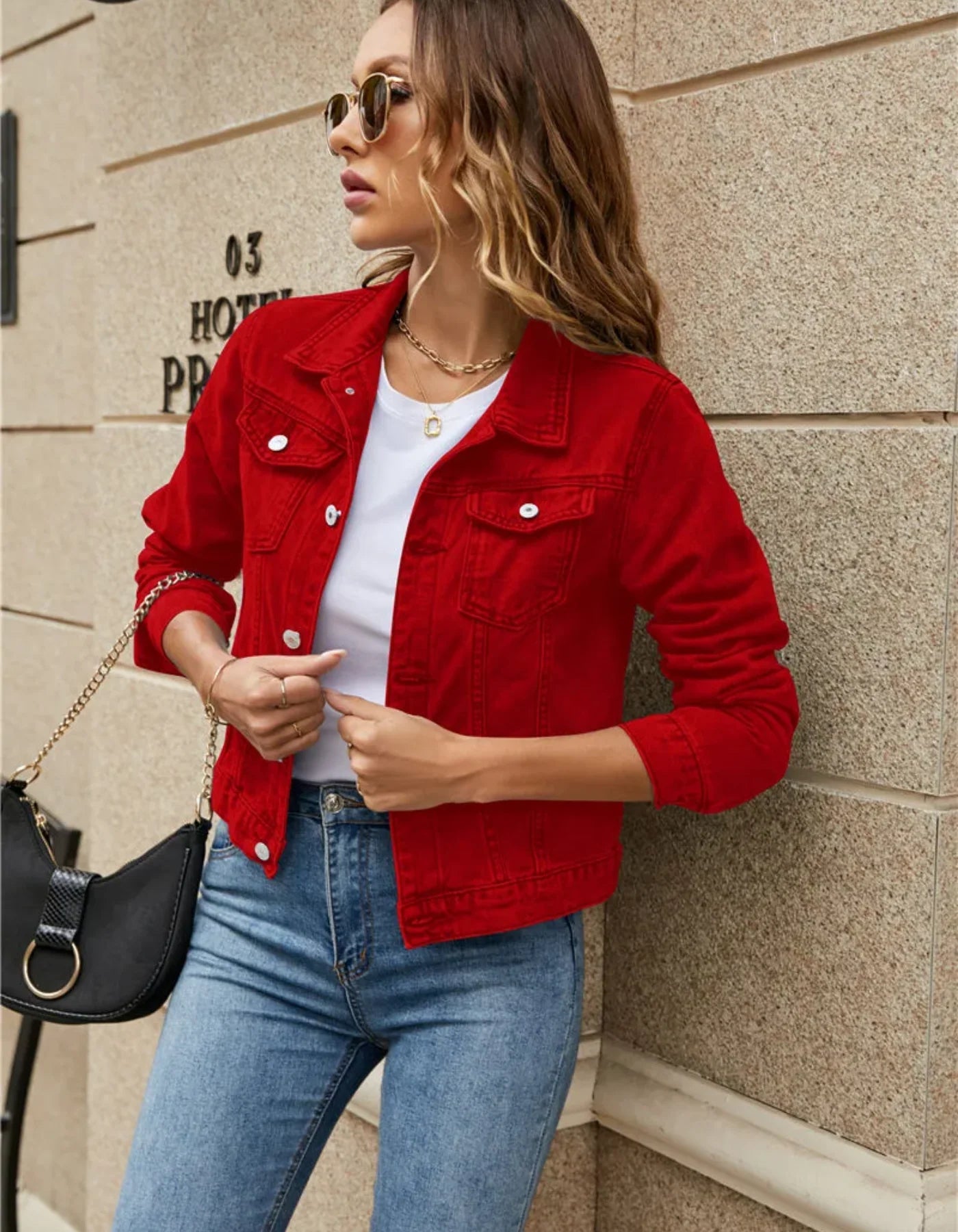 Women's cropped denim jacket worn open showing flattering waist-length cropped design