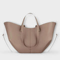 Women's curved tote bag in taupe with dual handles and detachable shoulder strap on white background