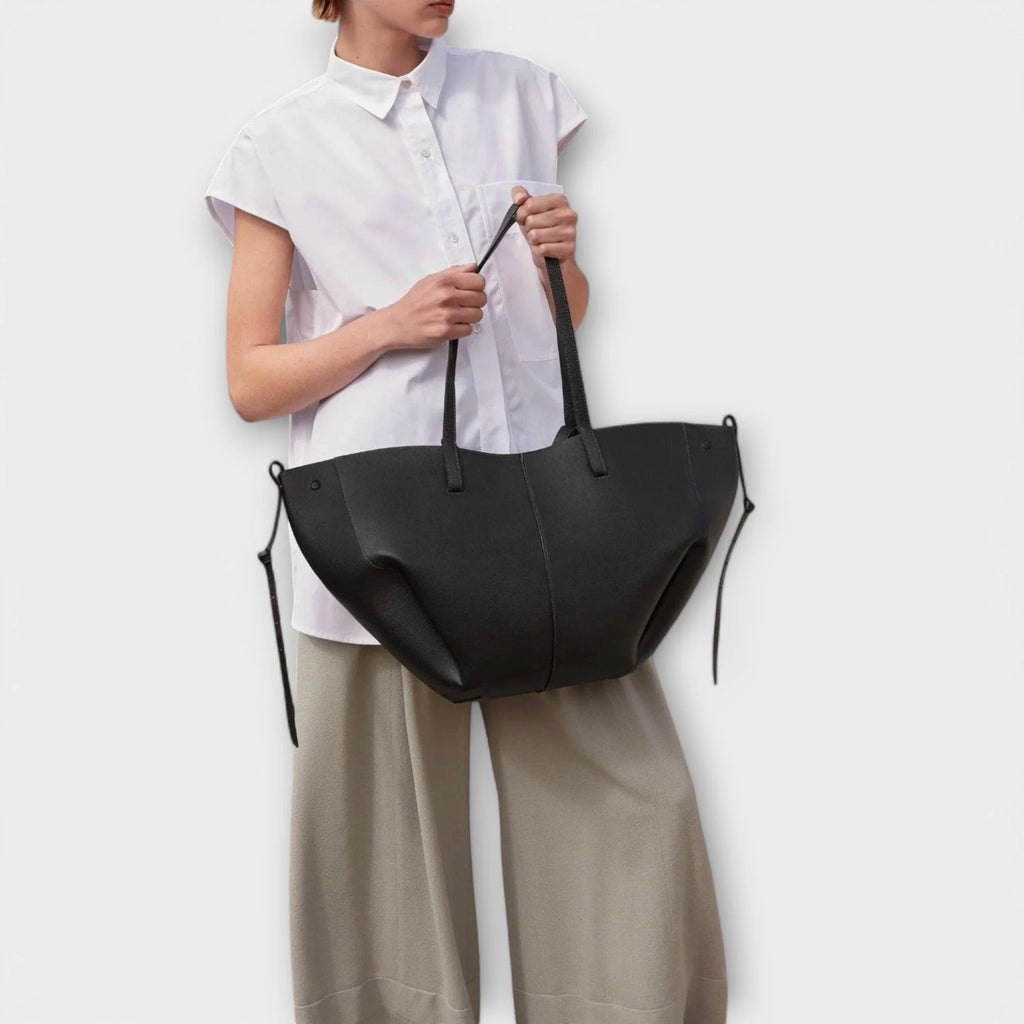 Curved tote bag in taupe worn as handbag showing versatile styling options