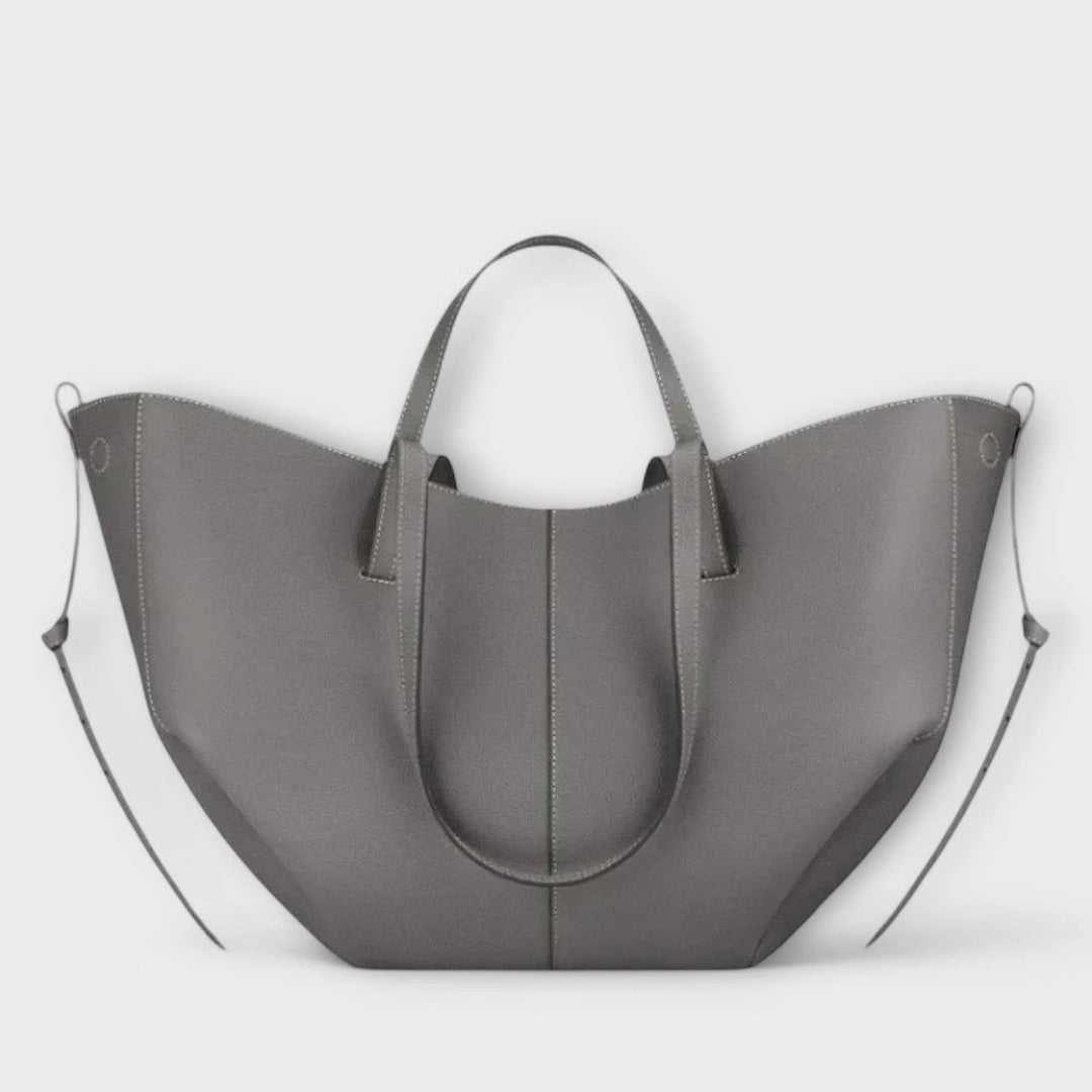 Curved tote bag interior view showing spacious compartment and magnetic closure mechanism