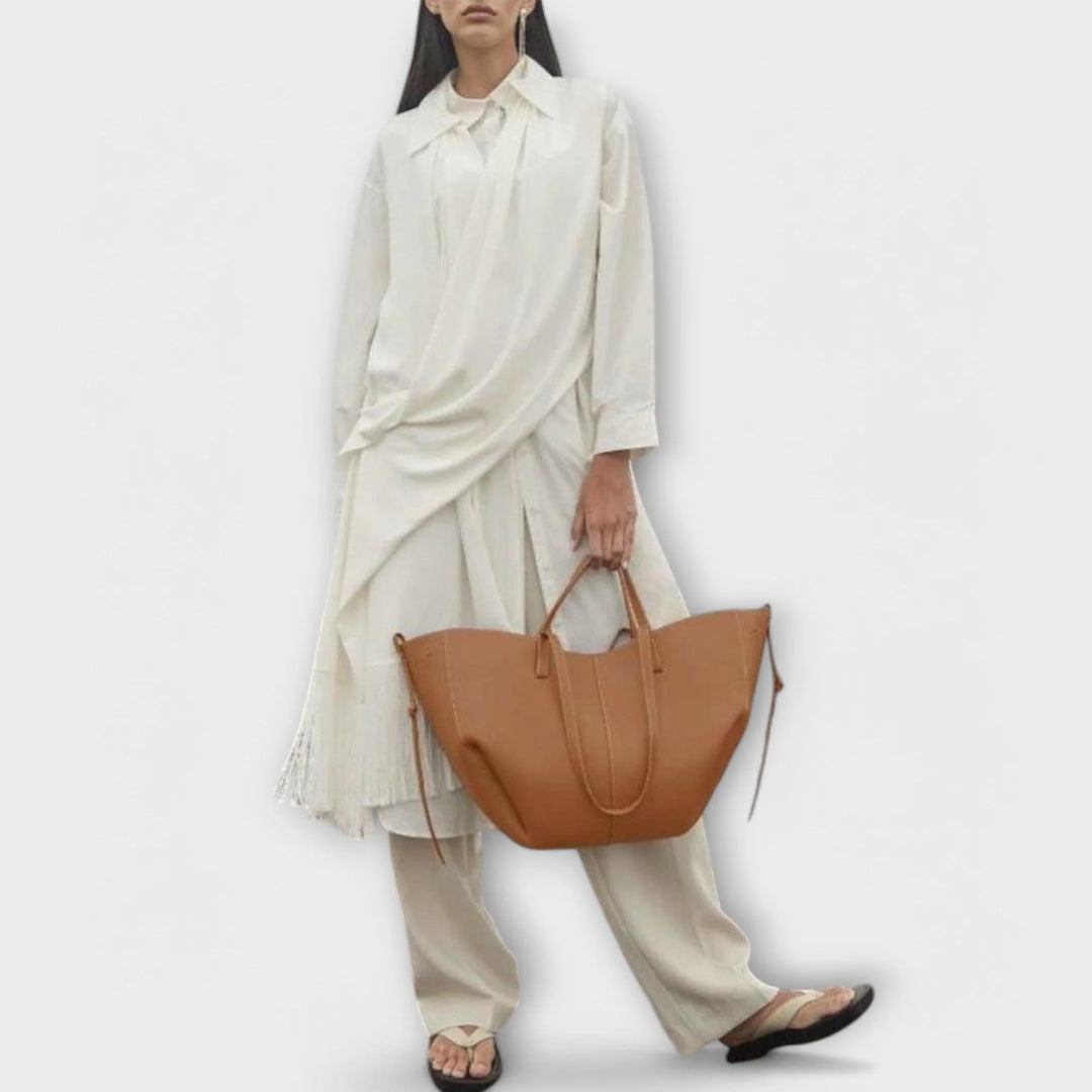 Women's crescent tote bag close-up showing clean stitching and refined hardware details