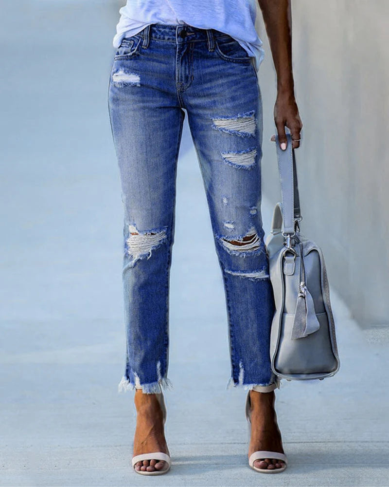 Women's ripped jeans with raw frayed hem and casual relaxed fit