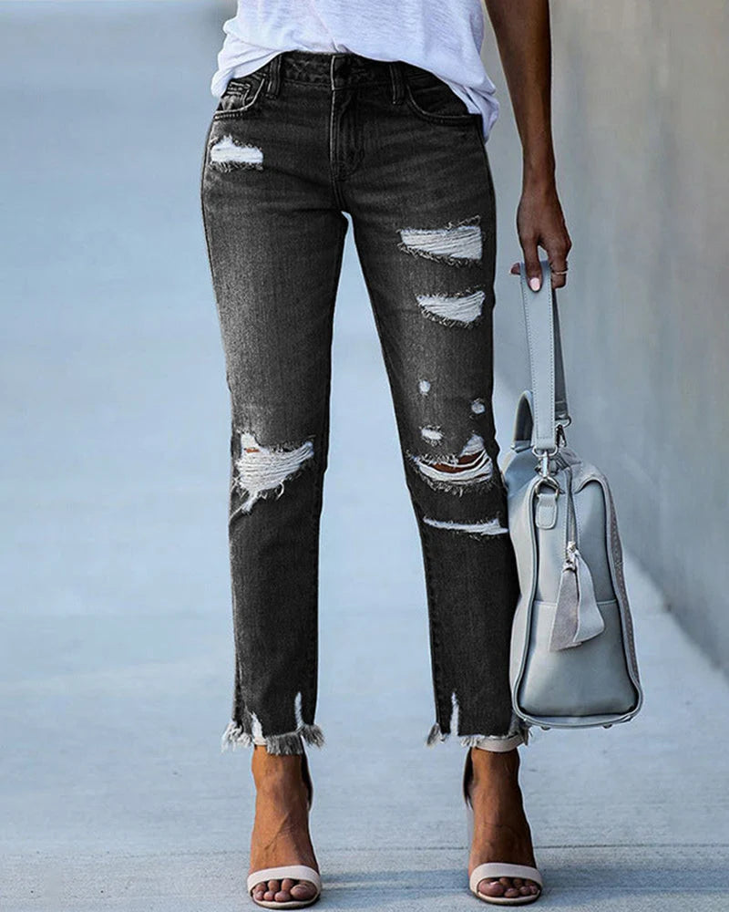 Distressed straight leg jeans in light blue wash with knee rips