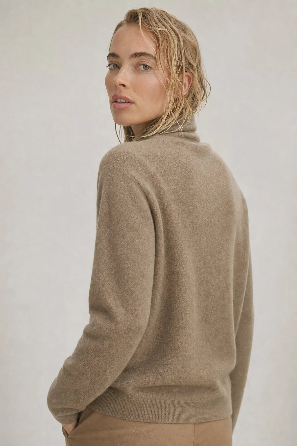 Close-up of mohair sweater V-neck wrap detail showing soft knit texture and draped front