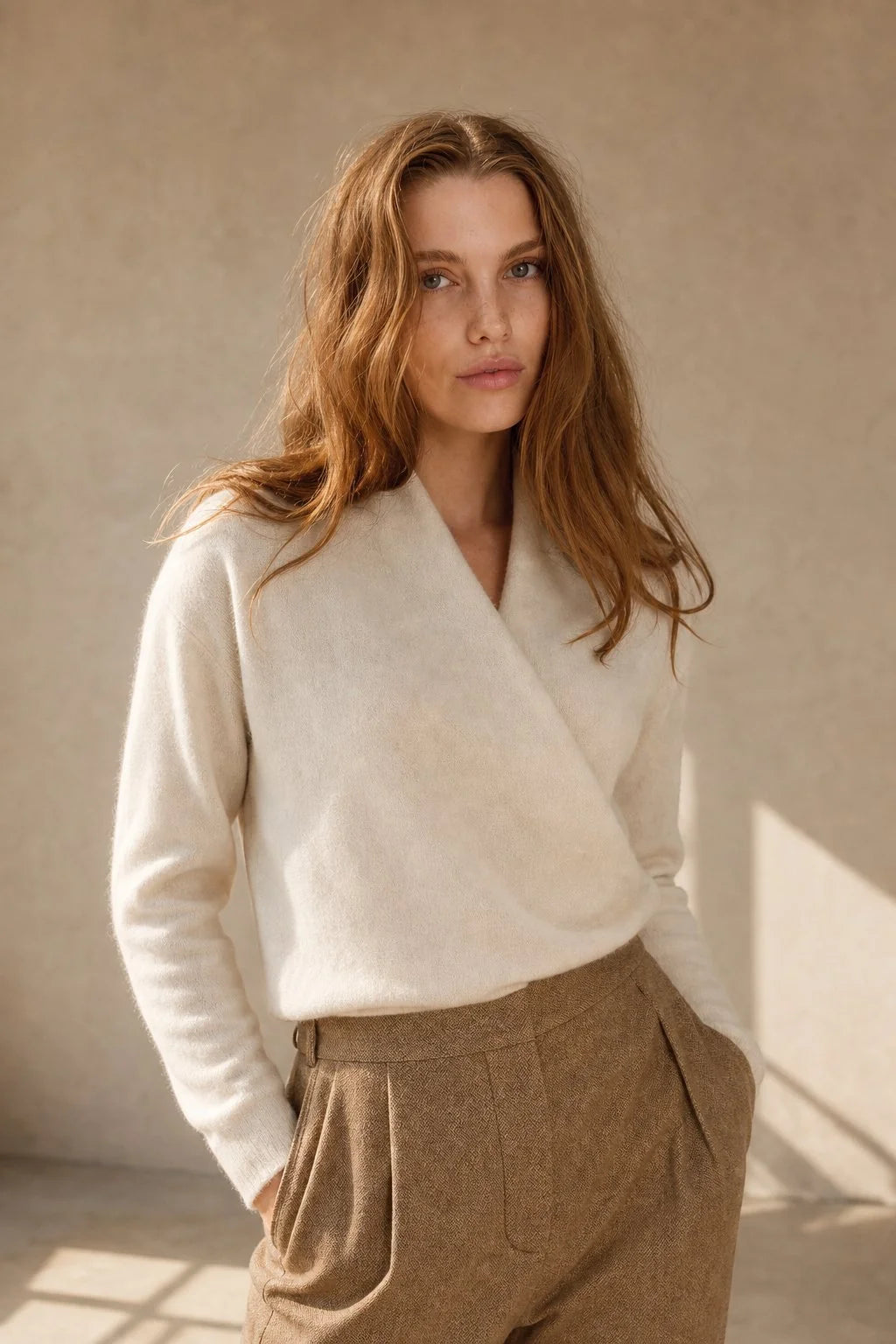 Side view of women's mohair sweater with ribbed cuffs and relaxed silhouette