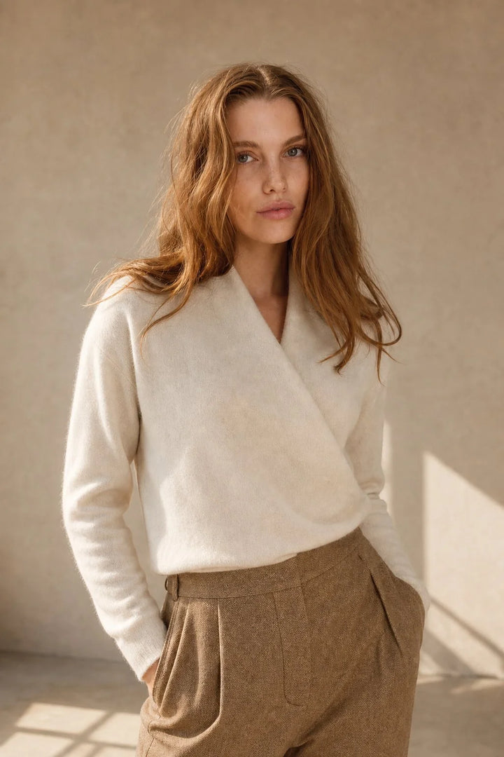 Side view of women's mohair sweater with ribbed cuffs and relaxed silhouette
