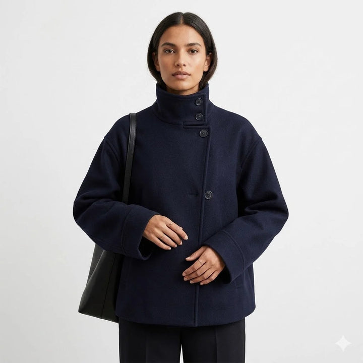 Detail of women's wool coat button closure and high neckline construction