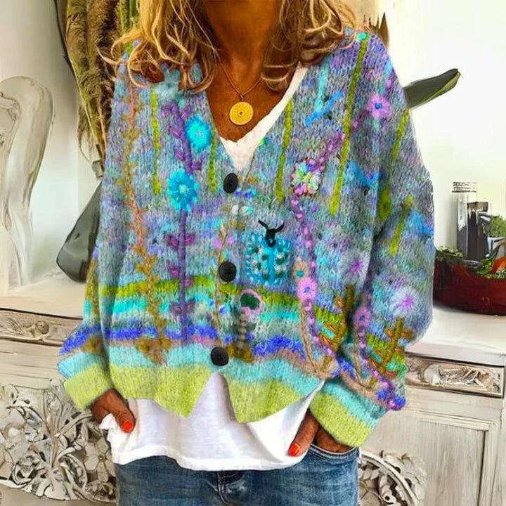 Close-up view of multicolour floral embroidery on textured knit cardigan with ribbed cuffs