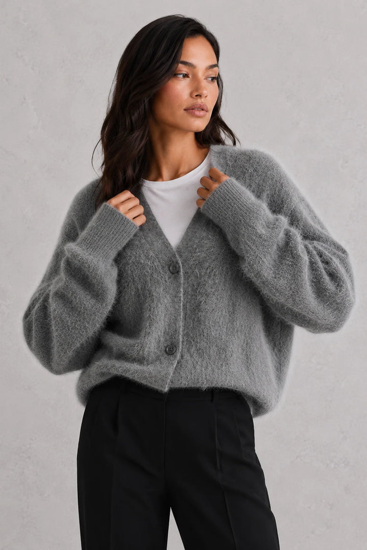 Detail shot of cardigan's V-neckline and plush knit surface texture