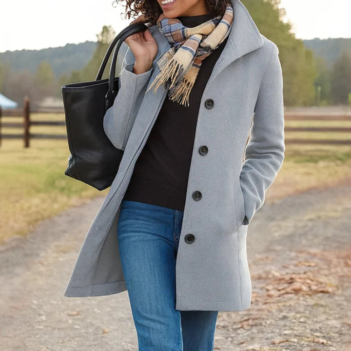 Back view of classic funnel neck coat with smooth finish and knee-length cut