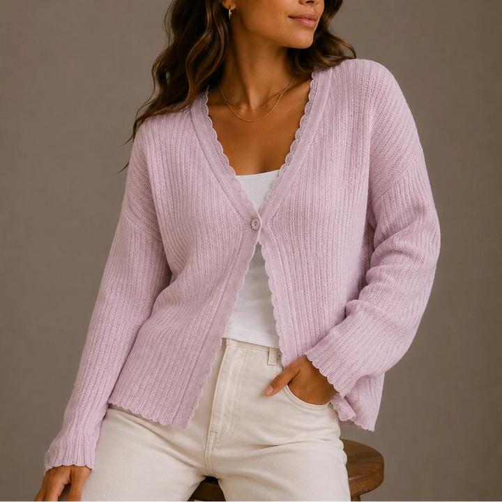 Back view of women's knit cardigan displaying ribbed construction and hip-length cut