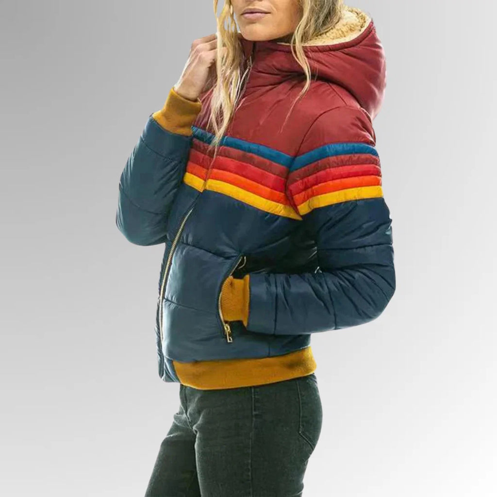 Detail shot of women's puffer jacket showing quilted construction and stripe pattern across chest