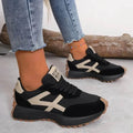 Women's retro trainers in black with beige contrast stripes and chunky textured sole
