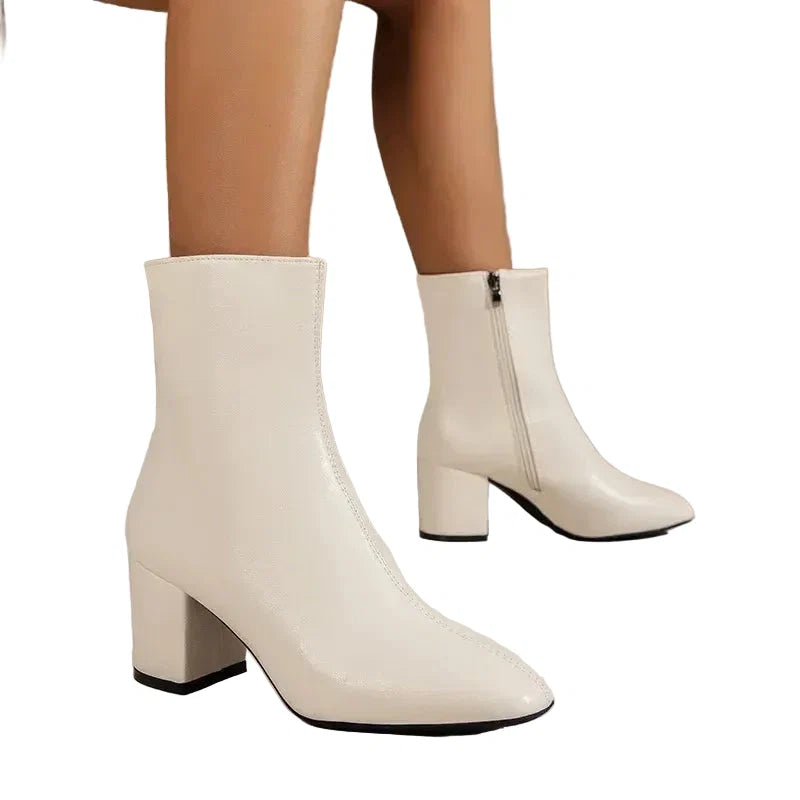 Side view of women's cream ankle boots showing block heel and streamlined ankle-height silhouette
