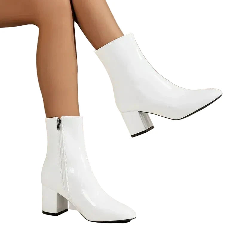 Women's cream ankle boots with block heel showing smooth finish and ankle-height cut