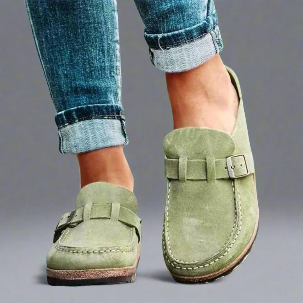 Detail shot of women's mules highlighting contrast stitching and suede-effect texture on upper