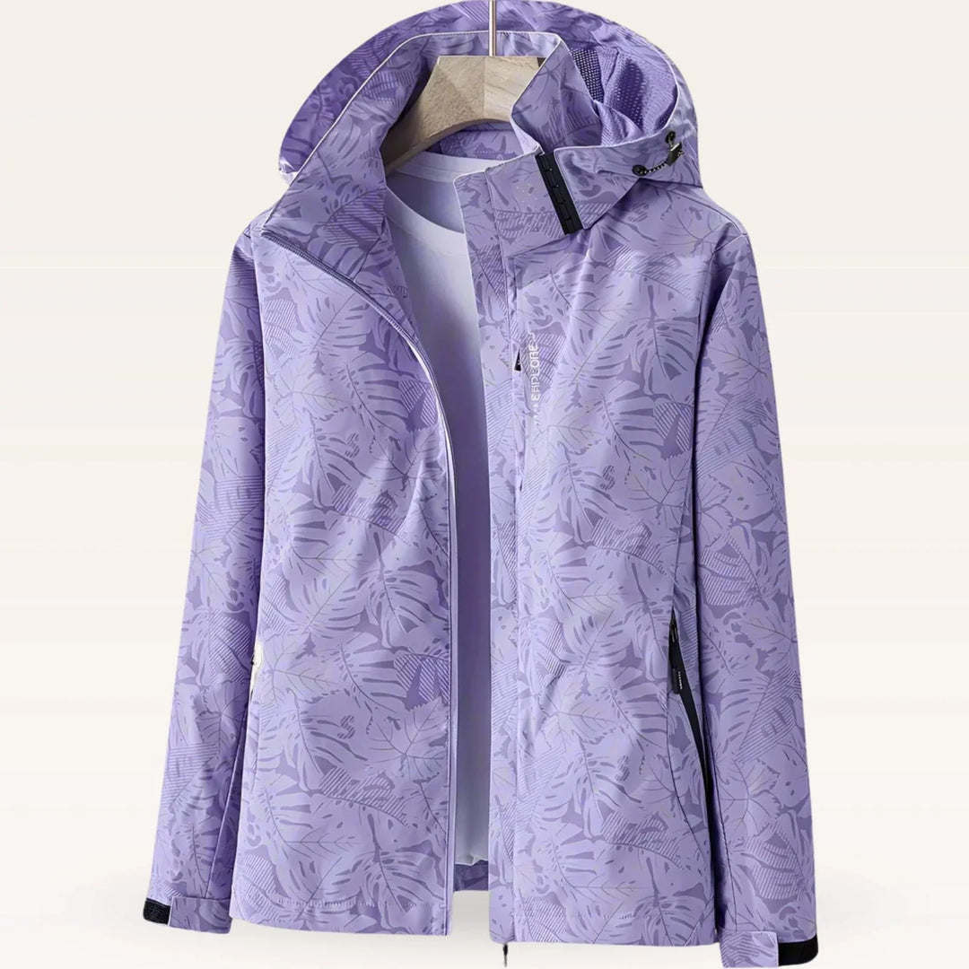 Side view of women's hooded windbreaker showing zip pocket and relaxed fit