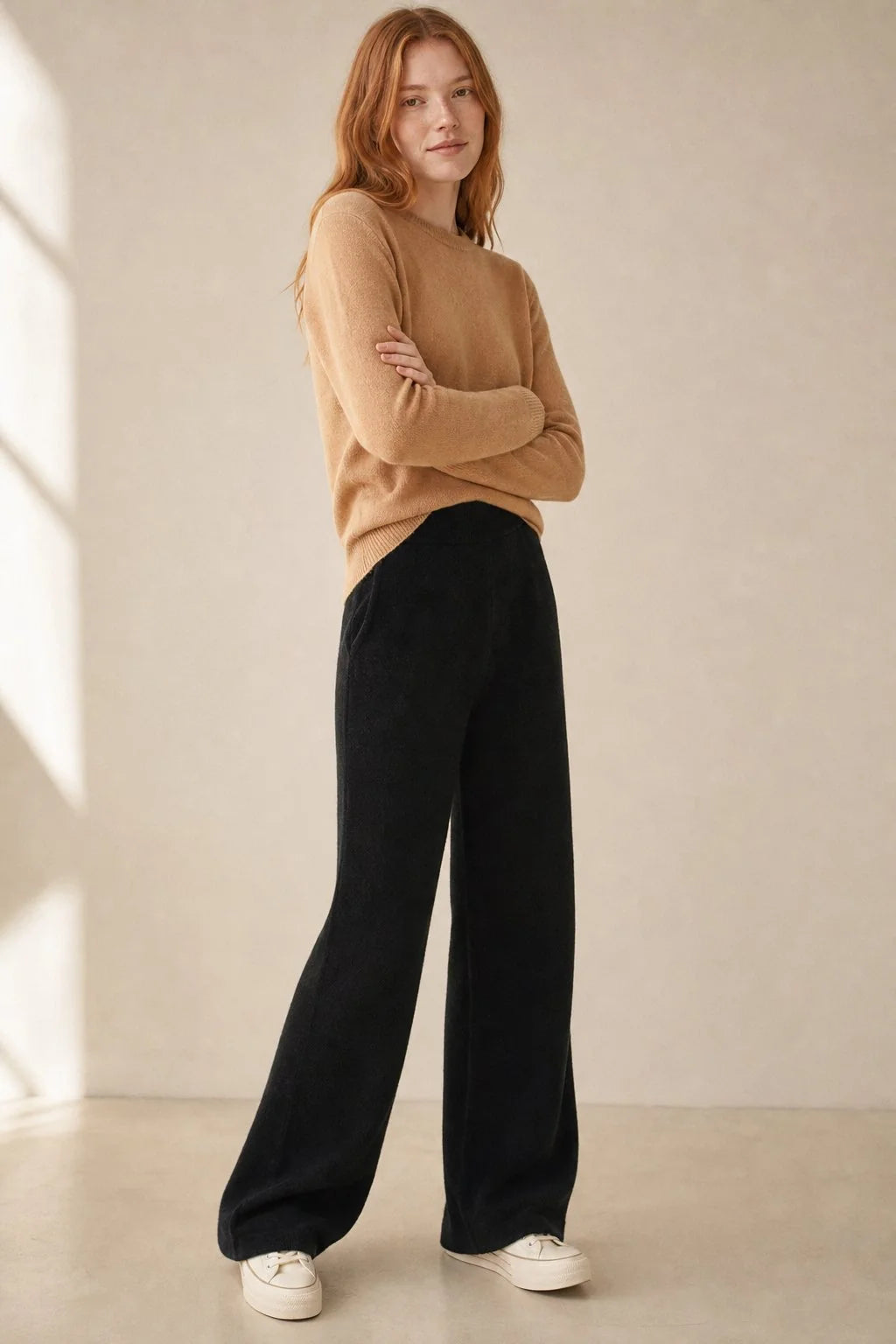 Full outfit view of cream wide-leg Merino Pants styled with knit jumper and trainers