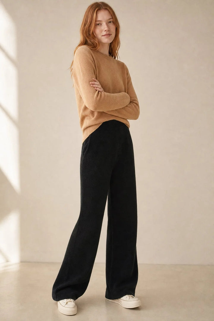 Full outfit view of cream wide-leg Merino Pants styled with knit jumper and trainers