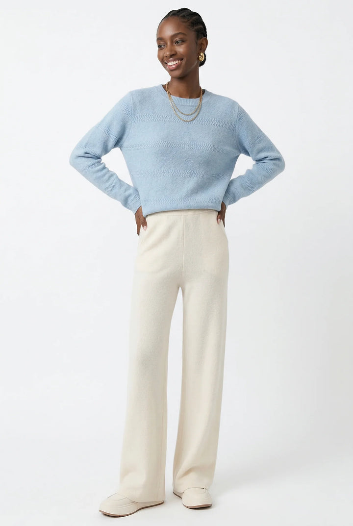 Woman in cream wide-leg Merino Pants showing relaxed fit and versatile styling options