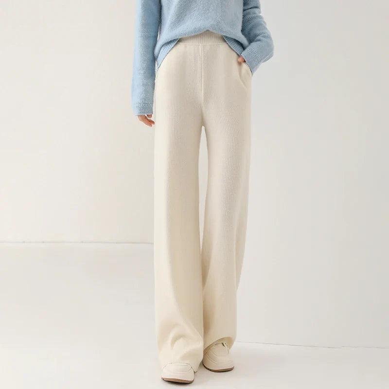 Full-length shot of woman wearing cream wide-leg Merino Pants with casual footwear