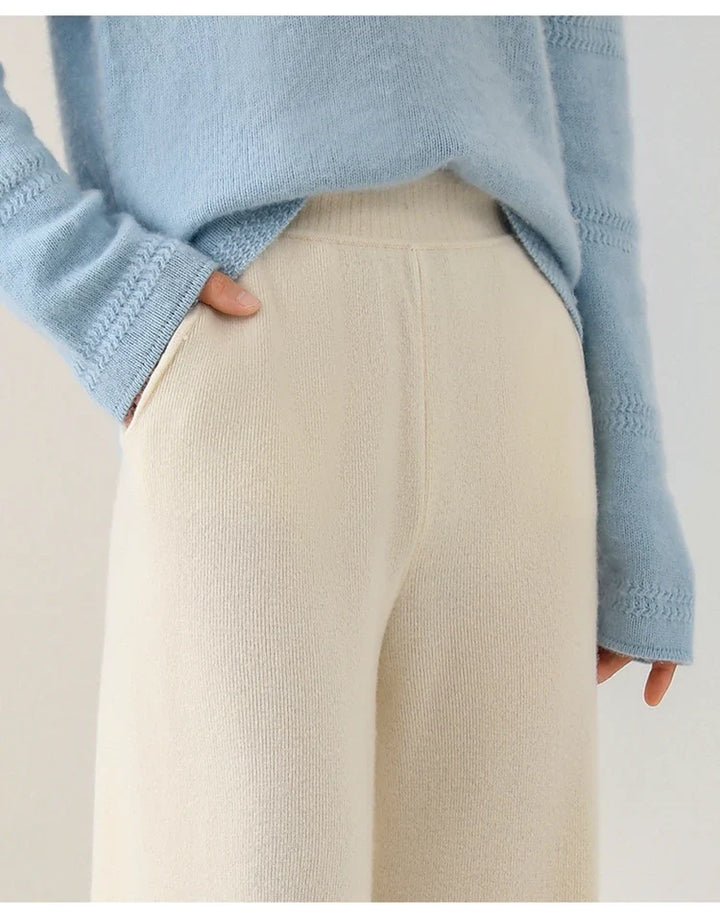 Woman seated in cream wide-leg Merino Pants demonstrating comfortable relaxed fit