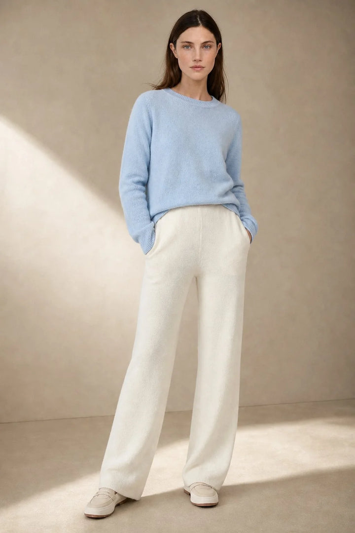 Close-up view of cream Merino Pants showing soft knit fabric texture and wide-leg silhouette