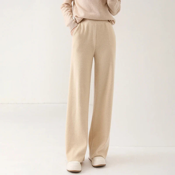 Side view of cream wide-leg Merino Pants highlighting high waist and flowing silhouette