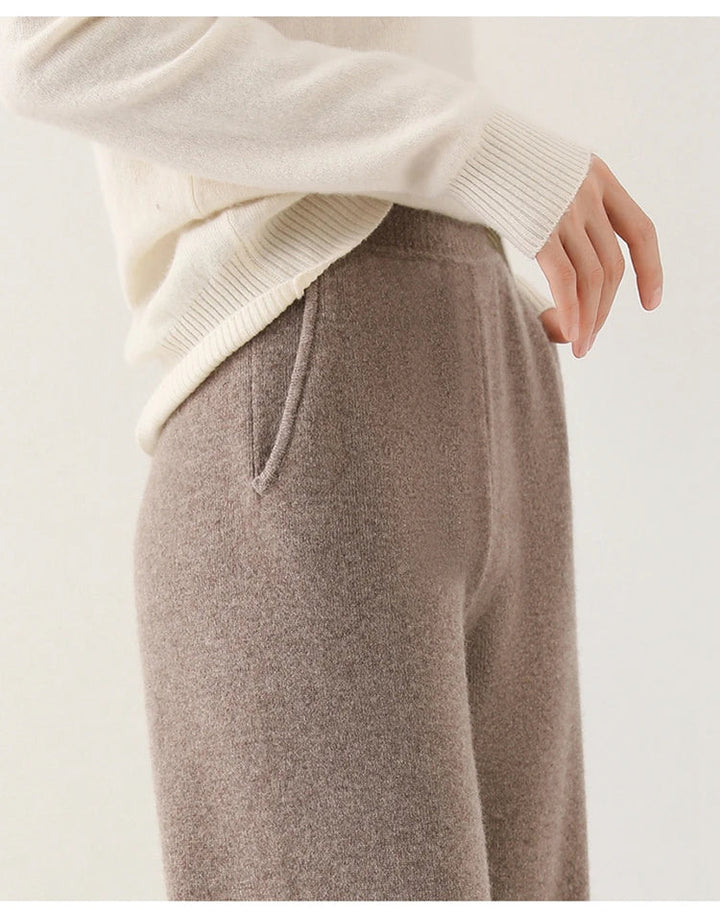 Woman seated in cream wide-leg Merino Pants highlighting comfortable relaxed fit