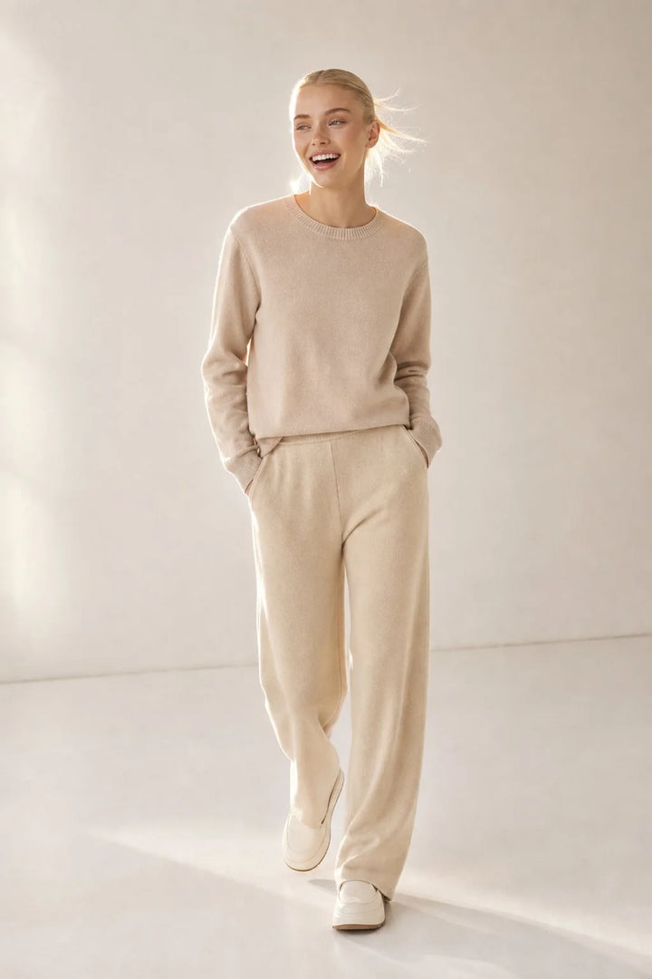 Side view of woman in cream wide-leg Merino Pants highlighting relaxed drape and high waist design