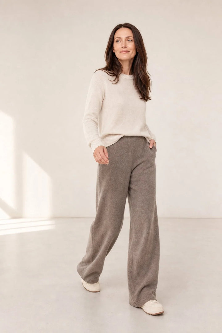 Full-length view of cream Merino Pants showing wide-leg cut and natural fabric drape