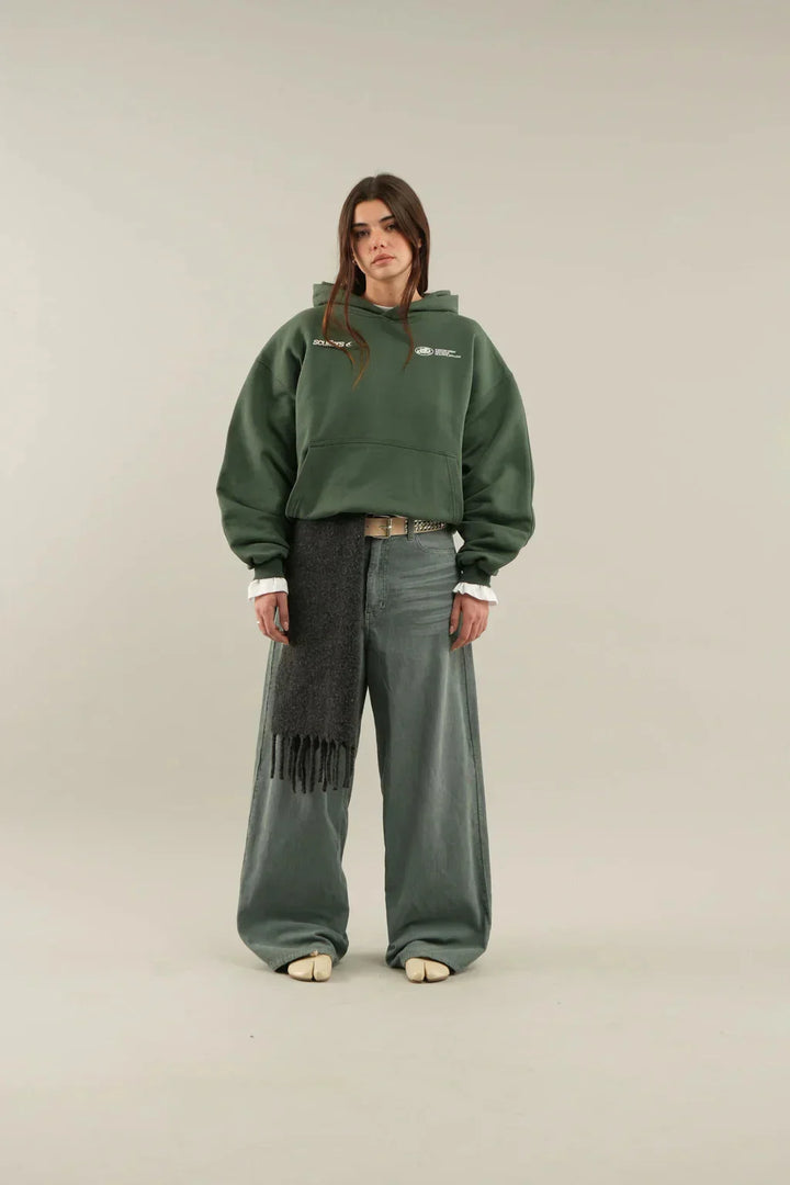 Women's oversized hoodie shown with hood up, highlighting adjustable drawstring detail