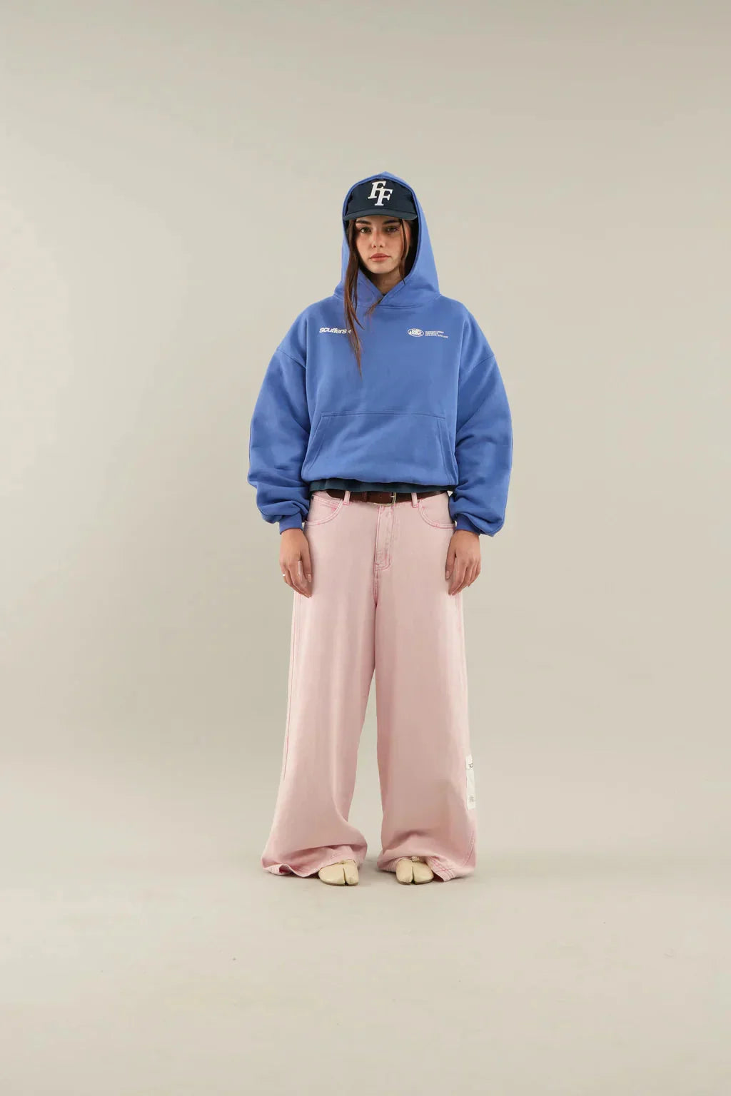 Women's oversized hoodie paired with jeans, showing cropped length and oversized silhouette