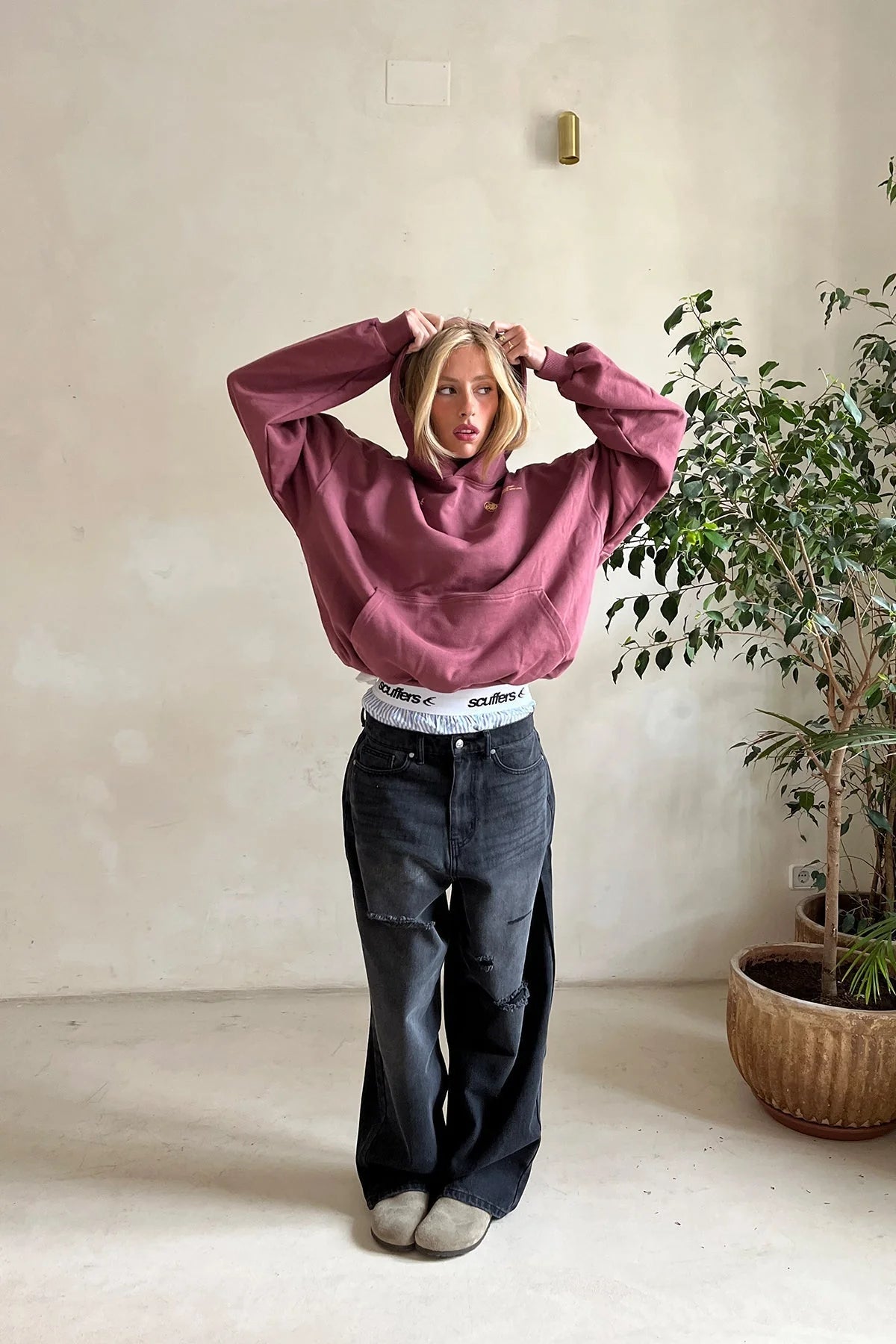Close-up of women's oversized hoodie showing kangaroo pocket and fleece interior construction
