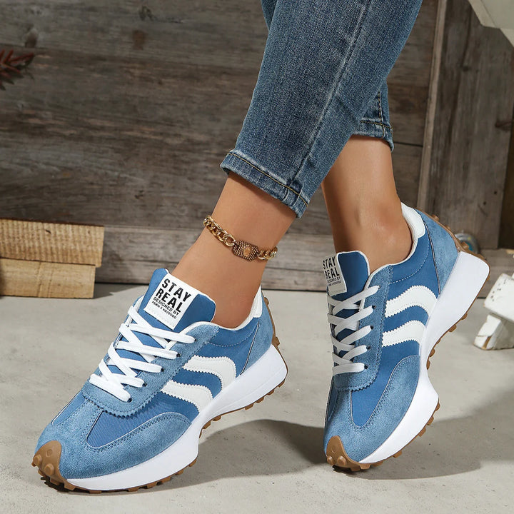 Overhead view of women's retro trainers showing lace-up closure and padded tongue detail