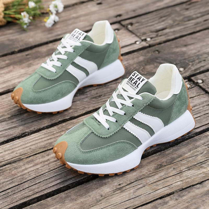 Side view of women's retro running trainers with contrast stripes and chunky white midsole