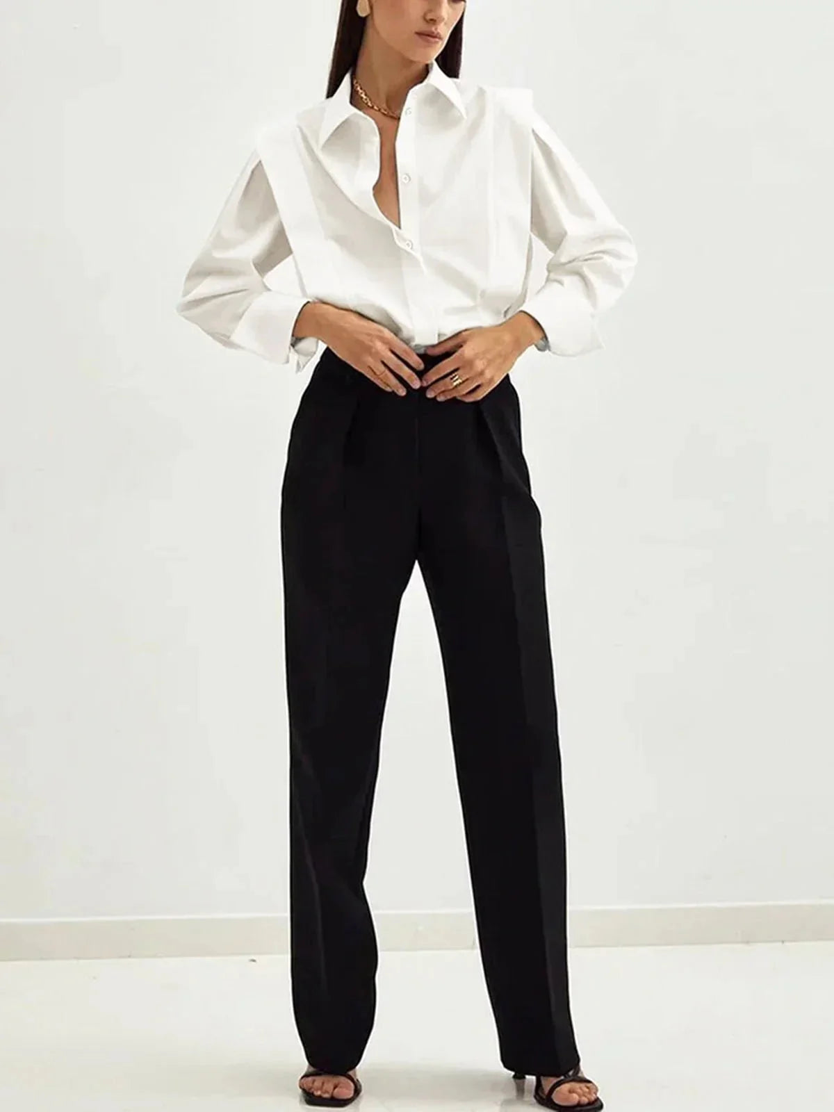 Women's white button-up shirt with long sleeves and buttoned cuffs detail